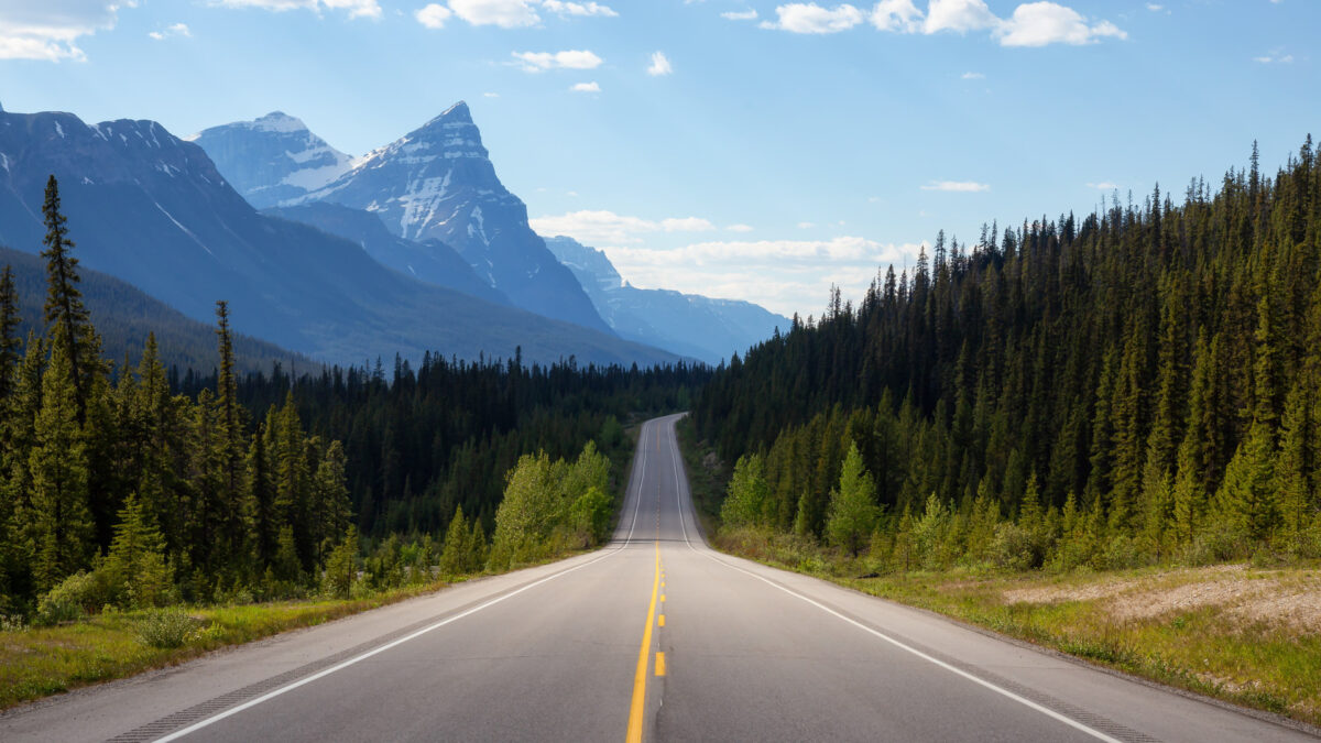 Rechte weg door de Rockies met bergtoppen op de achtergrond in Jasper National Park, Canada – reizen met Explore