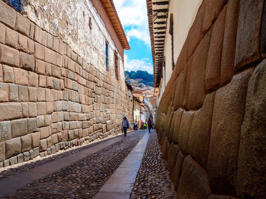 Straat in Cusco met indrukwekkende Inca-muur van grote keien, Peru – reizen met Explore.